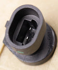Brake master cylinder for International 4700 with hydraulic booster; black plastic round port, close-up view