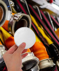 Sleek Iron Fire Sprinkler Nozzle Cover Plate With Tough Head Protector And Snug Ceiling Escutcheon to mask holes, held in hand.