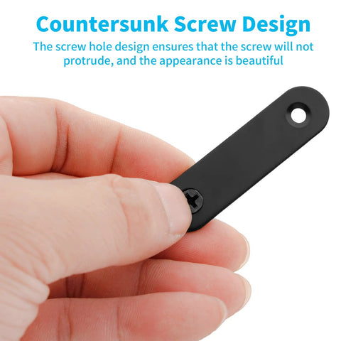 Hand holding 20 Sets Black Stainless Steel Flat Plate Straight Brackets For Wood 2 Inch 50x16x2 Mm with countersunk screws