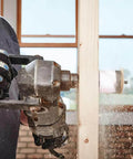 Lenox 2-3/4in bi-metal speed-slot hole saw, side view, mounted on a drill cutting wood.