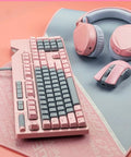 Dope Pink Mechanical Gaming Keyboard And Mouse Combo With Full Spectrum RGB Backlighting on a soft mouse pad with headphones.