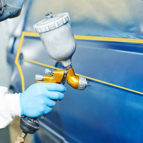 Person using spray gun with Pro Grade Fineline Pinstripe Tape Set With Four Widths One Sixteenth Inch One Eighth Inch One Quarter Inch And One Half Inch And Sixty Yard Length For DIY Car Paint Art Masking Tape That Stays Put And Delivers Clean Lines For Sharp Auto Finishes on car