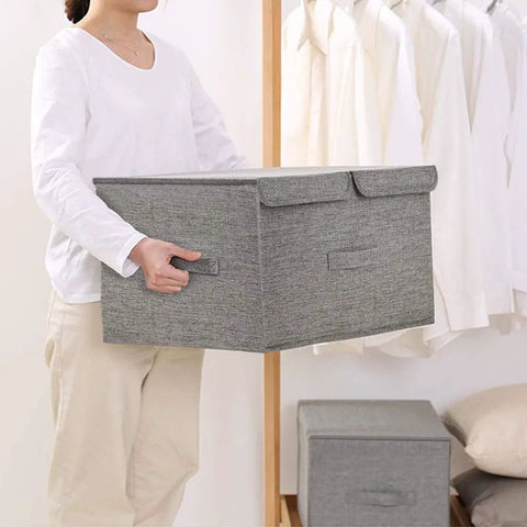 Collapsible Linen Fabric Storage Bin For Clothes Shoes And Toys Nifty Foldable Home Basket being held by a person in white shirt.