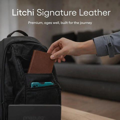 Straight Up The No Sweat Apple Find My Compatible Passport Holder With Built In Tracking And Mfi Certification Featuring Heavy Duty Rfid Shielding Plus A Three Year Rechargeable Battery For Super Smooth Trips In Brown being placed in a backpack pocket.