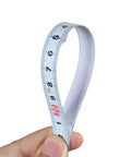 Precision Folding Tape Measure And Measuring Ruler Kit For Tough Woodworking Jobs High Visibility White Finish held in hand showing clear markings.