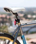 Lumina 1000 Boost Front Bike Light With Sabre 110 Rear Light USB Rechargeable LED Set mounted on a bicycle seat post