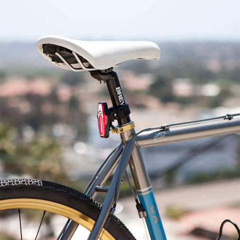 Lumina 1000 Boost Front Bike Light With Sabre 110 Rear Light USB Rechargeable LED Set mounted on a bicycle seat post