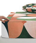 Cloud Soft Queen Fitted Sheets With 16 Inch Deep Pocket Microfiber Bedding Set Includes Two Pillowcases close-up with hand, retro design.