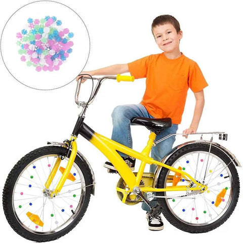 Child on yellow bike with Multicolor Bicycle Spoke Beads Set With Luminous Plastic Clips Durable Clip Beads For Kids Bikes