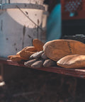 Heavy Duty Full Grain Cowhide Cold Weather Mittens Built Dang Tough With Heat Keep Thermal Insulation piled on a workbench.