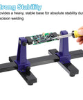 Adjustable PCB Holder With 360 Degree Rotation For Circuit Board Soldering And Desoldering Repair, Metal Base Workbench Desk Stand, Holds Up To 20 x 14 Cm Boards, Blue, shown securing a circuit board with a soldering iron in use