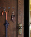 Four Pack Cast Iron Heart Wall Hooks Black Heavy Duty Hook For Keys Belts Towels Super Sturdy Rust Proof Finish holding umbrella and keychain.