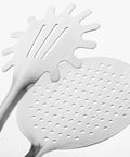 Stainless steel frying tongs and strainer kitchen tool close-up