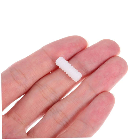 100 Pcs Nylon Hidden Fasteners And Double Headed Furniture Connectors To Keep Shelves And Cabinets Locked Down Tight With A Smooth Clean Look Heavy Duty Workshop Gear For Reliable Diy Build, white fastener held between fingers.