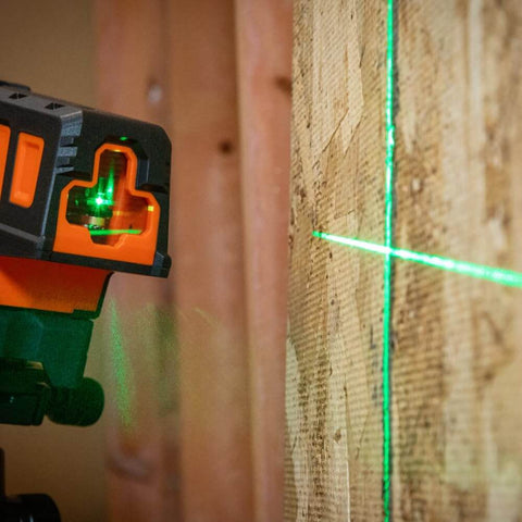 Compact Self Leveling Laser Level With Plumb Spot, Bright Green Cross Lines, 75 Foot Range, Class 2 Laser attached to wood surface