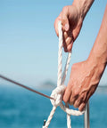 Hands tying a knot on 5/8 Inch By 150 Ft Double Braid Polyester Rope For Arborist And Sailboat Use, smooth and hand-friendly
