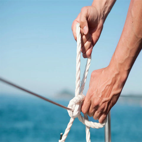 Hands tying a knot on 5/8 Inch By 150 Ft Double Braid Polyester Rope For Arborist And Sailboat Use, smooth and hand-friendly