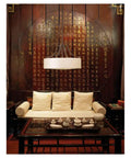 Living room with cushioned sofa, wooden table, and hanging Sunset Drive Two Light Flush Mount Ceiling Light in oil rubbed bronze.