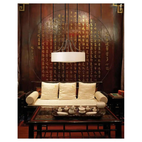 Living room with cushioned sofa, wooden table, and hanging Sunset Drive Two Light Flush Mount Ceiling Light in oil rubbed bronze.
