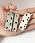 Stainless steel 2.5-inch folding butt hinge set in hand for wooden jewelry box lids