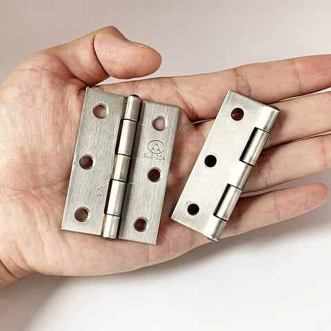Stainless steel 2.5-inch folding butt hinge set in hand for wooden jewelry box lids
