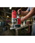 Milwaukee Style 1-5/8 Inch Auto Stop Electromagnetic Drill Kit with 13 amp motor drilling metal on a workshop table.