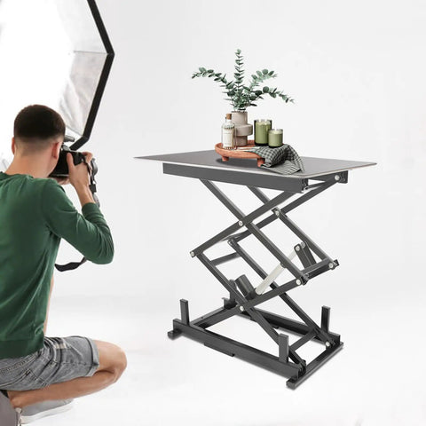 Rock Solid Electric Lift Table Rated For 180 Lbs Double Scissor Design with decorative items, adjustable height in use.