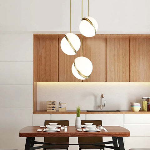 Three Acrylic Globe Pendant Lights With Irregular Hanging Design For Dining Room And Living Room, gold mount over dining table