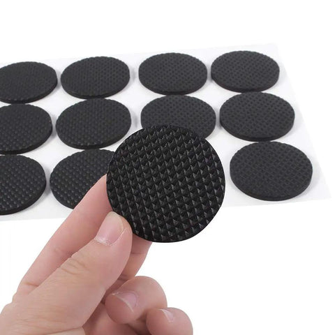 Close-up of 12 piece black rubber feet pads self adhesive floor protectors for furniture chairs and tables, non slip cushioning pads.