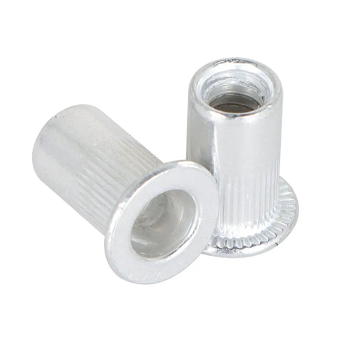 Close-up of aluminum rivet nuts from 100 Pcs kit, 10-24 UNC fasteners for auto and DIY projects, showing threaded inserts for metal panels.