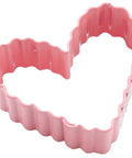 Angled view of pink metal crinkle-heart cookie cutter, 3-inch, 12-pack