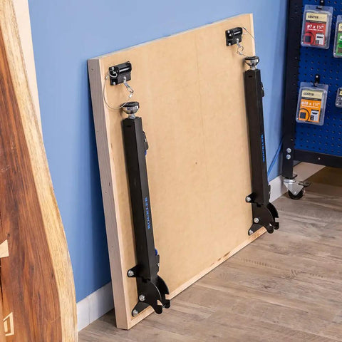 Folded Knock Down Outfeed Table Kit With Foldable Legs For Small Shops, Removable Extension For Table Saws, leaning against wall