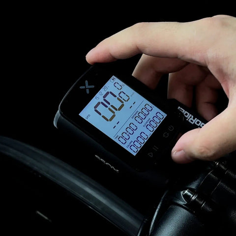 Gen2 GPS Ride Ready Bike Computer With Mount, 2.2 Inch Display being adjusted on handlebars by a hand, Bluetooth Wireless Cycling Speedometer visible