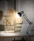 Metal Desk Lamp With Adjustable Arm And Clamp, 18 Inch Extension, Black Finish, UL Listed on desk, illuminating a book