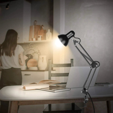 Metal Desk Lamp With Adjustable Arm And Clamp, 18 Inch Extension, Black Finish, UL Listed on desk, illuminating a book