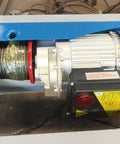 Close-up of motorized mechanism on High Capacity Electric Lift Table; steel cable and motor for heavy loads in warehouses.