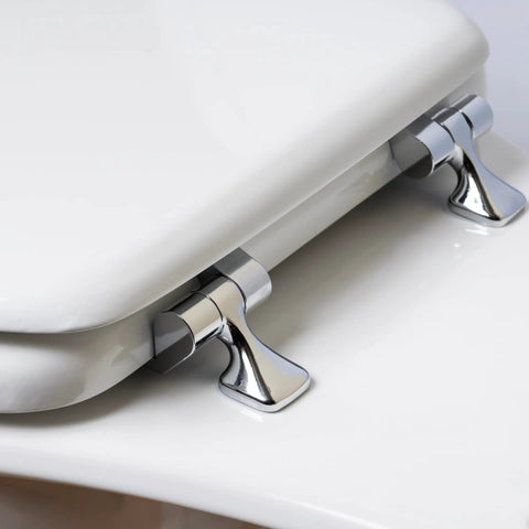 Close-up of snap tight chrome hinges on Elongated White Toilet Seat With Built Tough Enamel Construction and Snap Tight Chrome Hinges That Lock Securely.