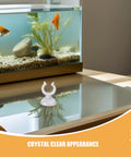 Ditch The Hassle And Get These 50pcs White Aquarium Air Hose Clamps With Rock Solid Suction Cups on a glass table near an aquarium.