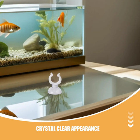 Ditch The Hassle And Get These 50pcs White Aquarium Air Hose Clamps With Rock Solid Suction Cups on a glass table near an aquarium.