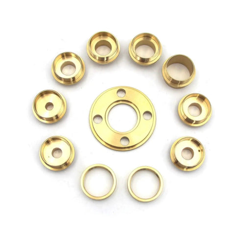 Solid As A Rock Metric Brass Router Guide Bushing Set showing eight brass guide rings and a central bushing for template tracking.