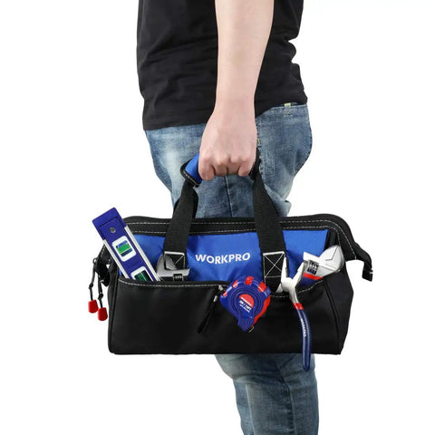 Person carrying 13" portable carry bag from 125 Piece Household Tool Kit With 3.6 Volt Cordless Rechargeable Screwdriver And 13 Inch Portable Carry Bag Great For DIY Projects And Everyday Home Repairs At Home Or On The Go.