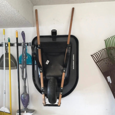 Heavy Duty Wheelbarrow Storage Bracket With Wall Mount Black Sturdy 80 Lb Capacity holding wheelbarrow in garage