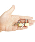 Hand holding two pack small solid brass padlocks with keys 20mm and 25mm mini key locks for luggage backpacks gym lockers jewelry boxes