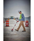 Man using Heavy Duty 6 Inch Measuring Wheel For Construction Sites Built Tough With Reinforced Pivot Top Brake Ergonomic Grip.
