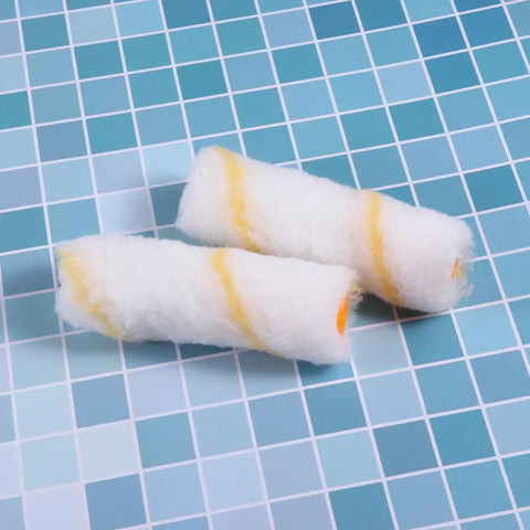 30 PCS Mini Paint Roller Sleeve Refills, High Density Foam Rollers For Wall Painting, two round mini roller sleeves on a tiled surface.