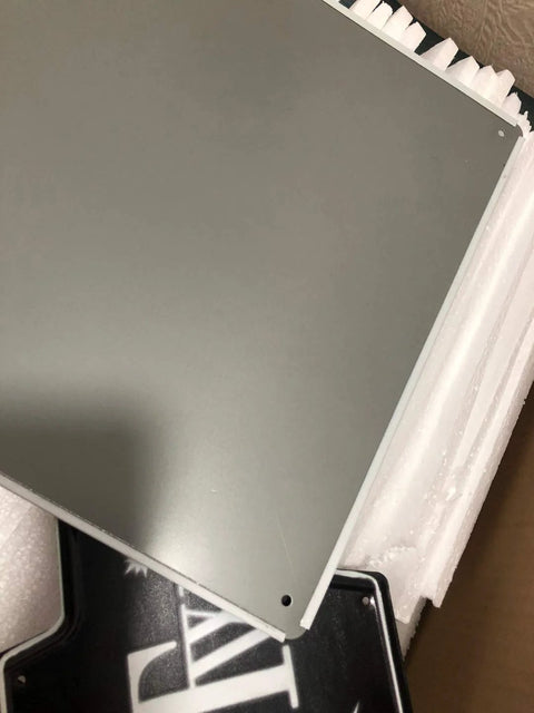 Aluminum sign panel, gray finish, 8 x 12 inches, with mounting holes in foam packaging