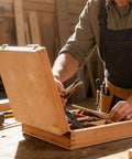 Carpenter using Two Pack 180 Degree Locking Hinges on wooden chest in workshop, ensuring stable lid support for long lasting performance.