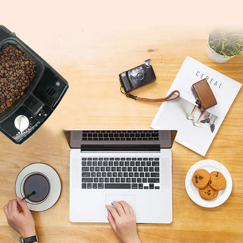 No Sweat Bean To Cup Coffee Maker With Fully Automatic One Button Brew, stainless steel body, coffee brewing at a workspace.
