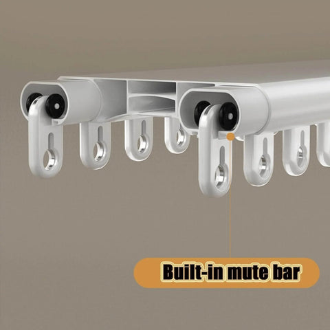 Close-up of heavy duty ceiling curtain track system with double rails, built-in mute bar, ceiling mounted in white finish.