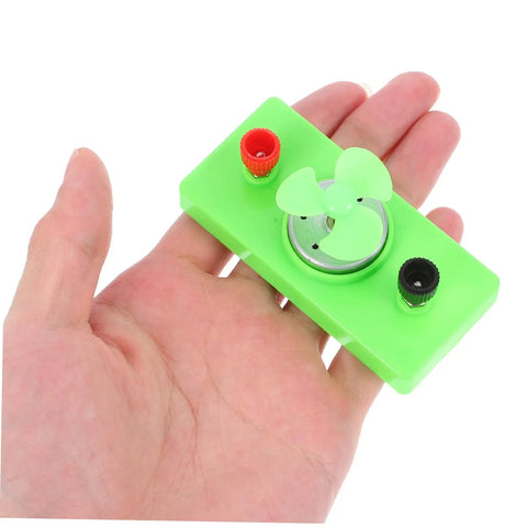 Hand holding Solar Powered DC Motor DIY Kit Wind Turbine Generator For Science Projects Sustainable Energy Learning Tool For Teens